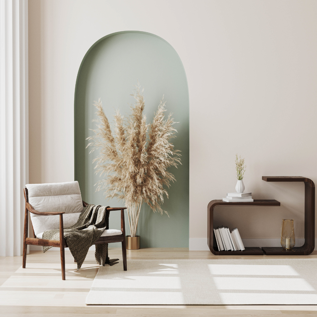 Minimalist living area with arched alcove, pampas grass decoration, mid-century armchair, and unique shelving unit