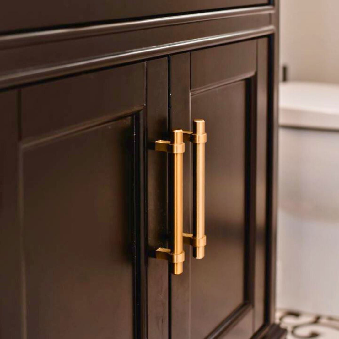 Modern black kitchen cabinets with shaker-style doors and long gold bar pulls