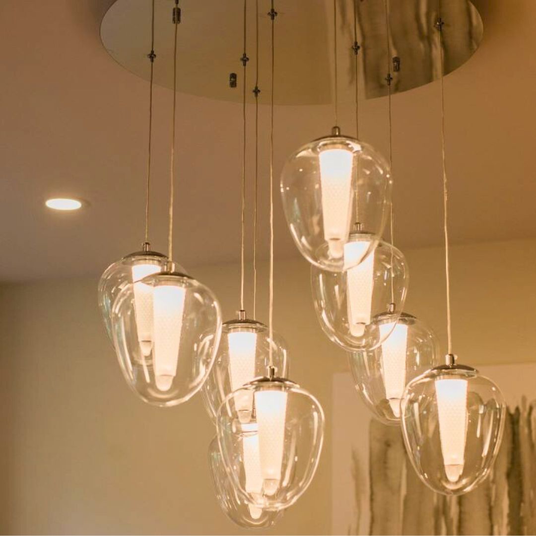 Elegant cluster of glass pendant lights with cone-shaped bulbs, creating a warm glow in a Hamilton home renovation project
